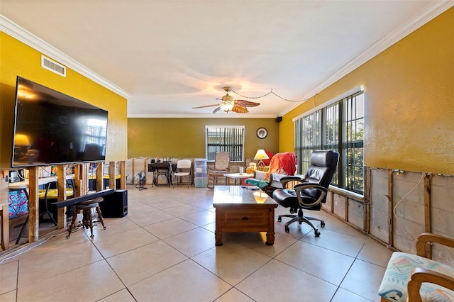 office space with crown molding, ceiling fan, and light tile patterned floors