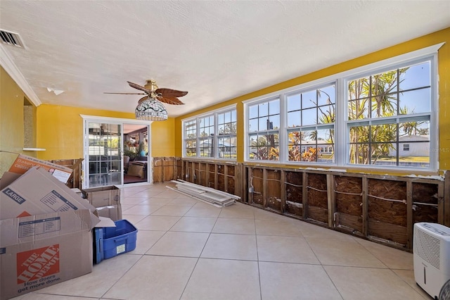 sunroom / solarium featuring ceiling fan