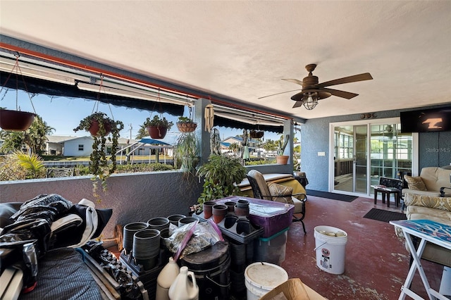 interior space with ceiling fan