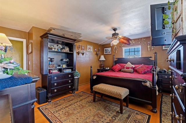 bedroom with light wood-type flooring and ceiling fan