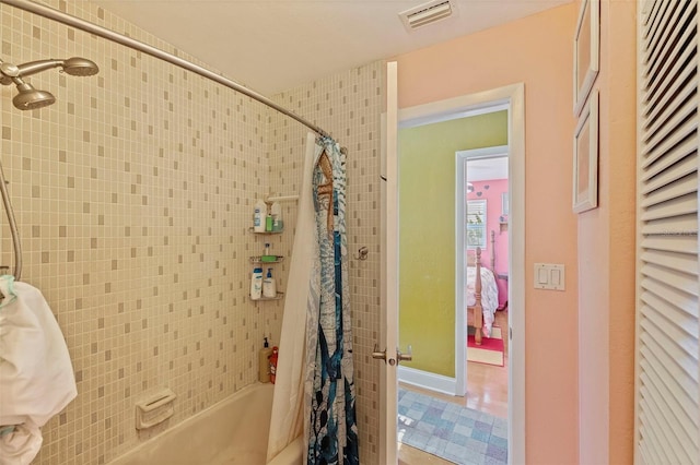 bathroom featuring tile patterned floors and shower / bath combo