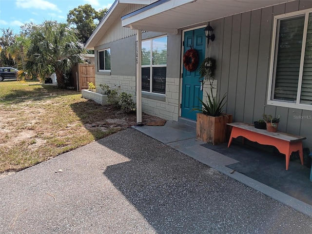 property entrance featuring a lawn