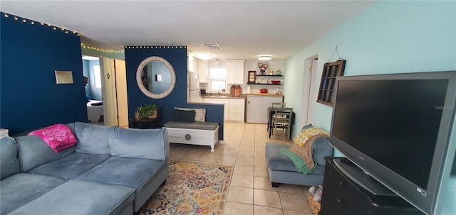 tiled living room featuring sink