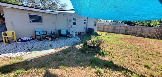 back of property with a patio area and central AC