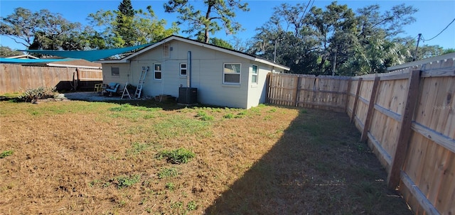 rear view of house featuring a yard and cooling unit