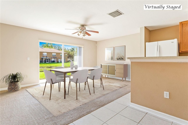 tiled dining space featuring ceiling fan