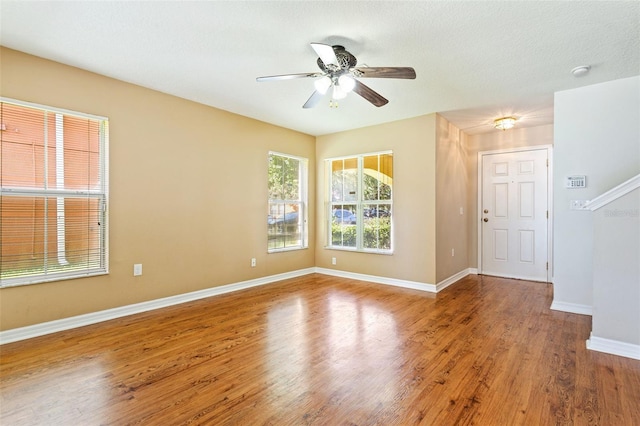 spare room featuring ceiling fan, wood-type flooring, and a textured ceiling