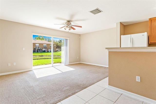 empty room with light colored carpet and ceiling fan