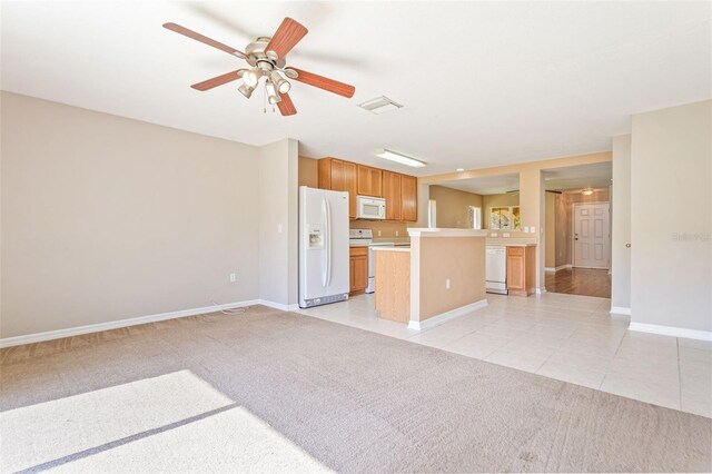 unfurnished living room featuring ceiling fan and light carpet