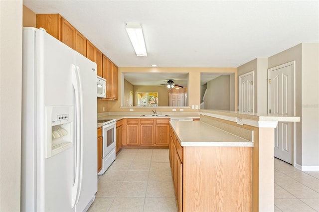 kitchen featuring kitchen peninsula, sink, light tile patterned floors, and white appliances