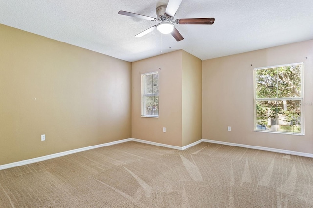 carpeted spare room with ceiling fan and a textured ceiling