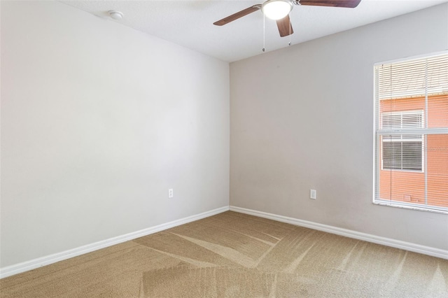 unfurnished room with carpet flooring and ceiling fan