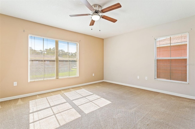 unfurnished room featuring light carpet and ceiling fan