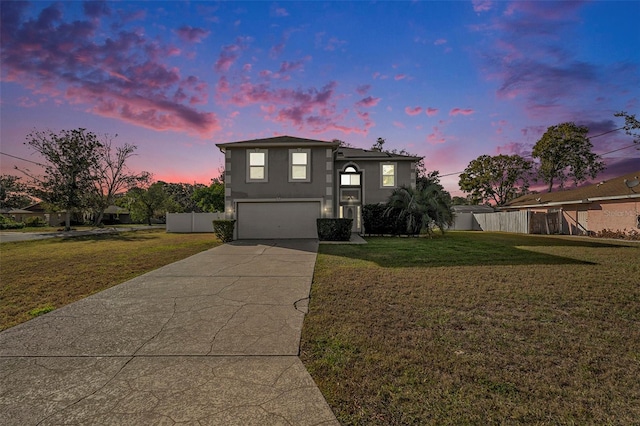 front facade with a lawn and a garage