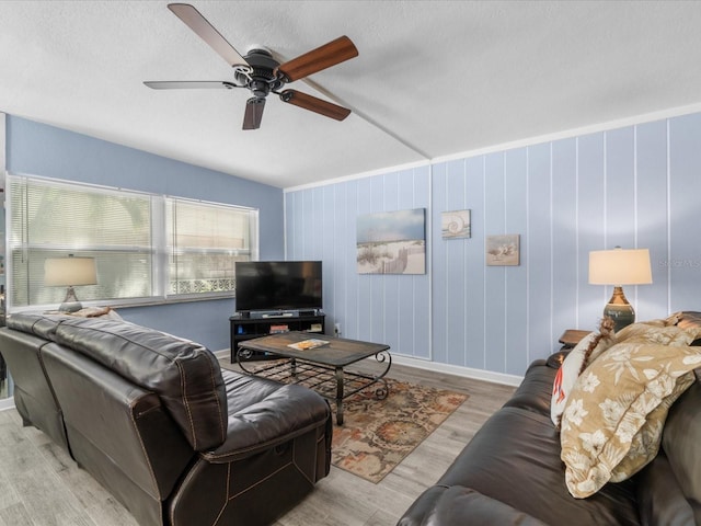 living room featuring ceiling fan and light hardwood / wood-style flooring