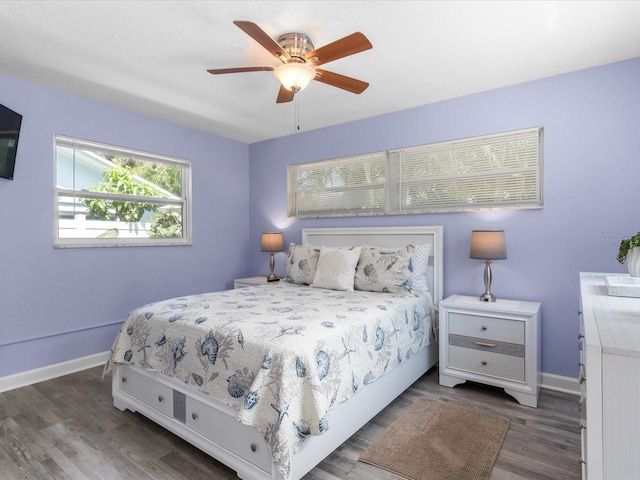 bedroom with ceiling fan and dark wood-type flooring