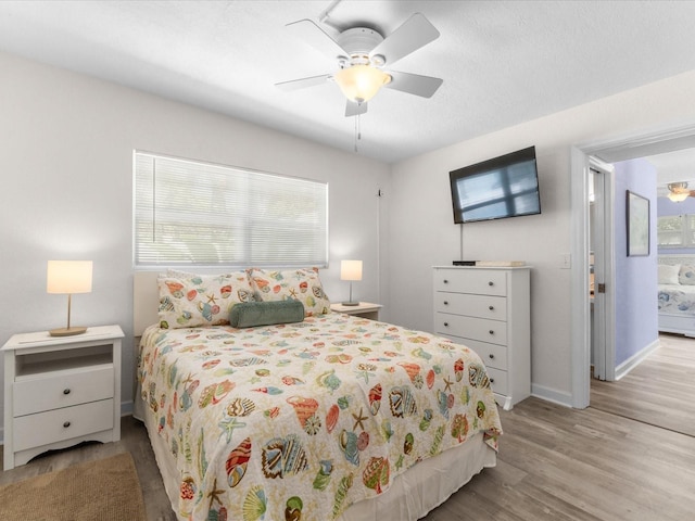 bedroom featuring ceiling fan and light hardwood / wood-style flooring