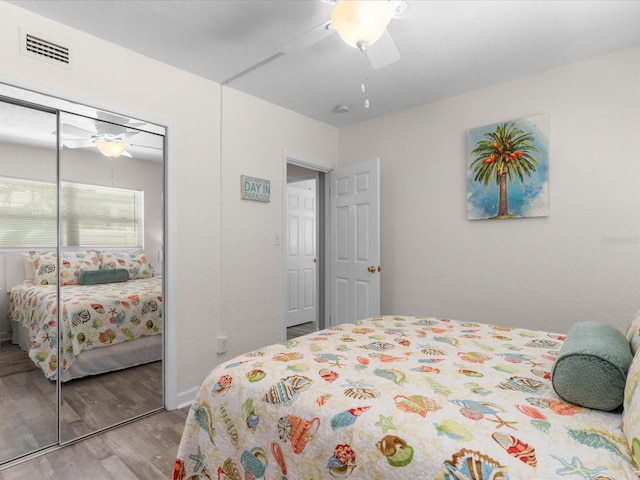 bedroom with light hardwood / wood-style flooring, a closet, and ceiling fan