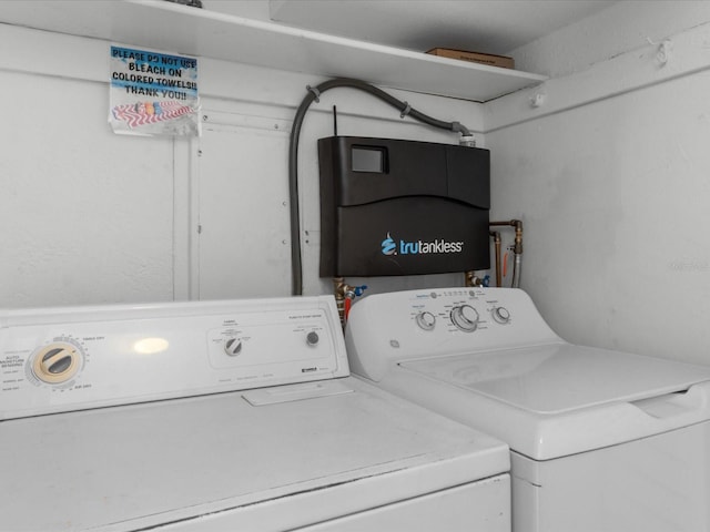 clothes washing area featuring independent washer and dryer