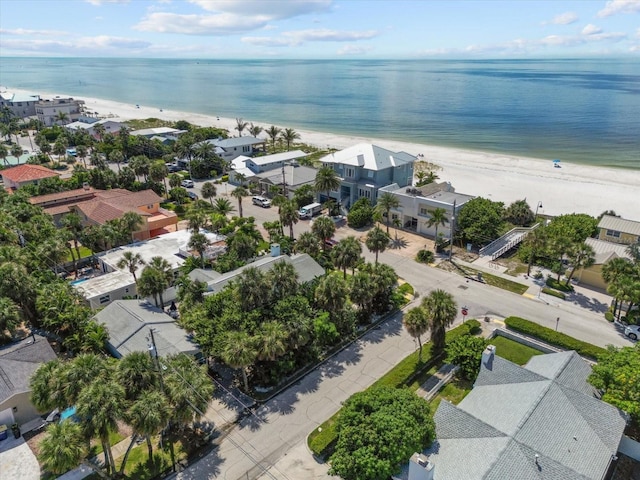 drone / aerial view featuring a water view and a beach view