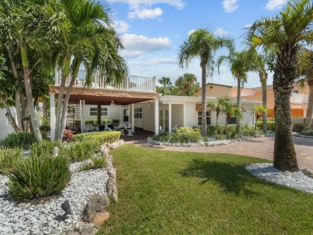 rear view of house with a lawn and a deck