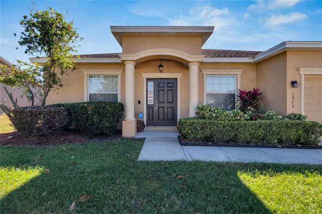 doorway to property with a yard