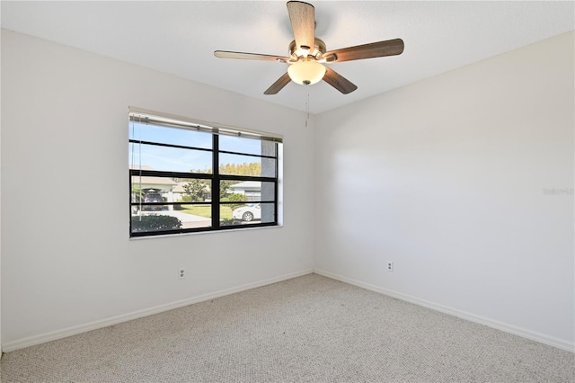 spare room featuring carpet flooring and ceiling fan