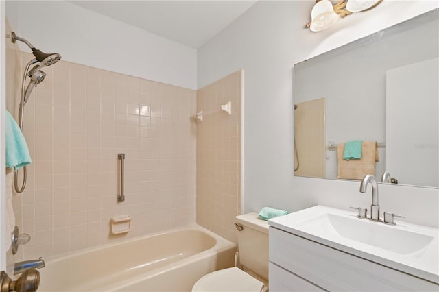 full bathroom featuring vanity, tiled shower / bath combo, and toilet