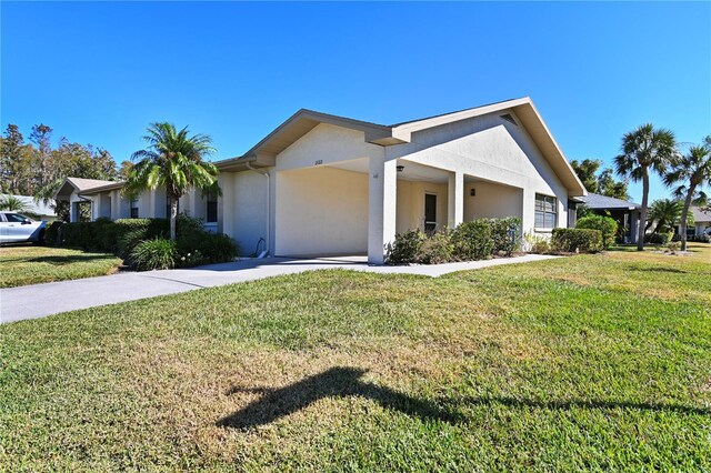 2122 Hereford Dr Unit 511, Sun City Center, FL 33573 - ranch-style house featuring stucco siding, driveway, a carport, and a front yard