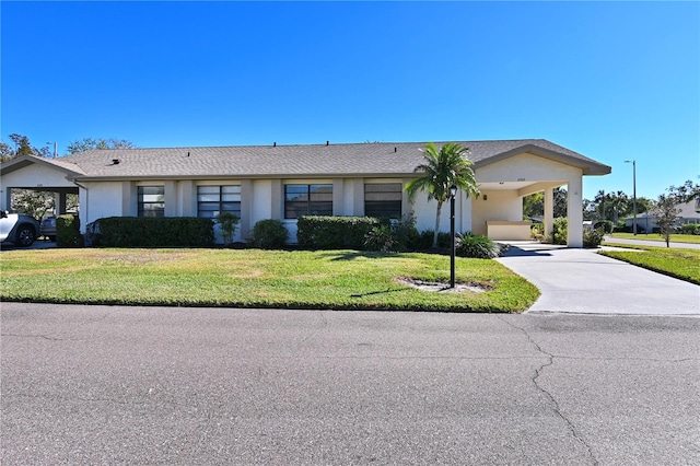 ranch-style house with a front yard and a carport