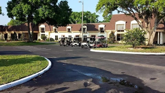 2122 Hereford Dr Unit 511, Sun City Center, FL 33573 - view of asphalt road with street lights and curbs