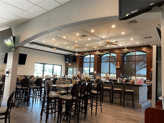 2122 Hereford Dr Unit 511, Sun City Center, FL 33573 - dining space with hardwood / wood-style floors, a ceiling fan, recessed lighting, a textured wall, and a community bar