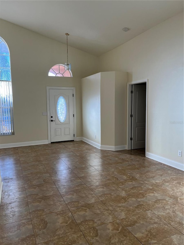 entryway featuring high vaulted ceiling