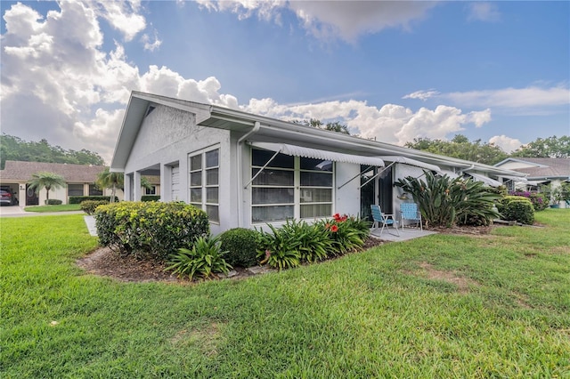 rear view of property with a lawn