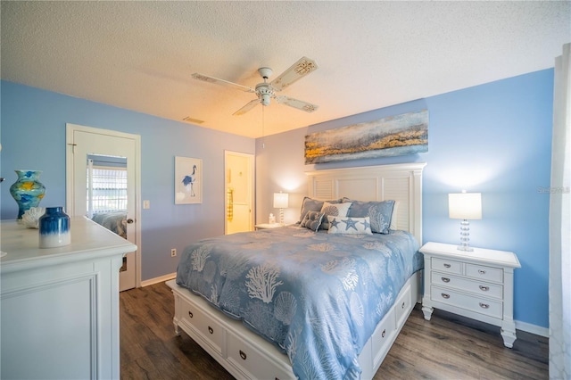 bedroom with a textured ceiling, ceiling fan, and dark hardwood / wood-style floors