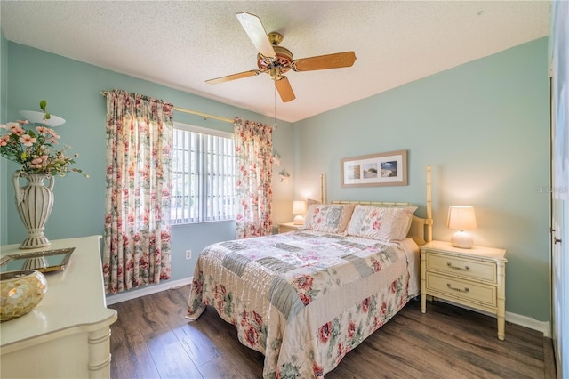 bedroom with ceiling fan, dark wood-type flooring, and a textured ceiling