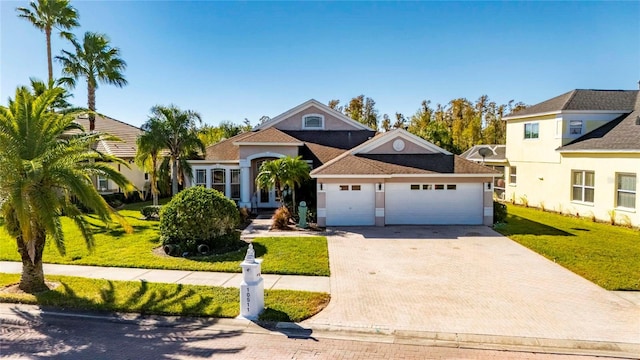 view of front facade featuring a front yard and a garage