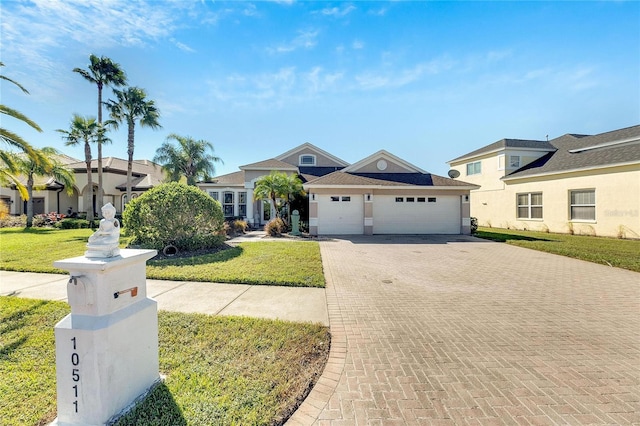 view of front facade with a garage and a front lawn