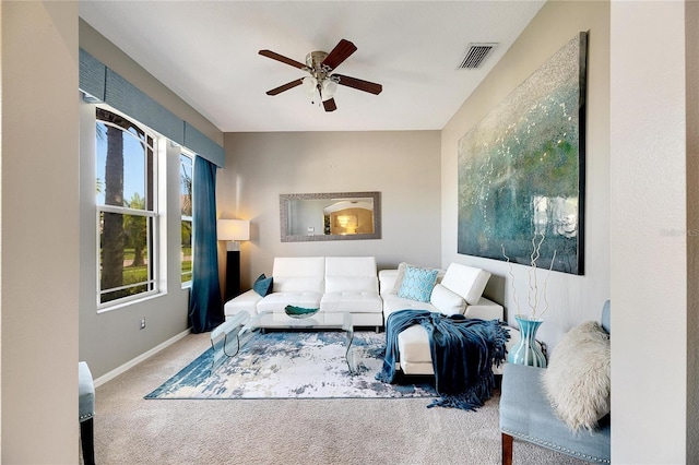 carpeted living room featuring ceiling fan