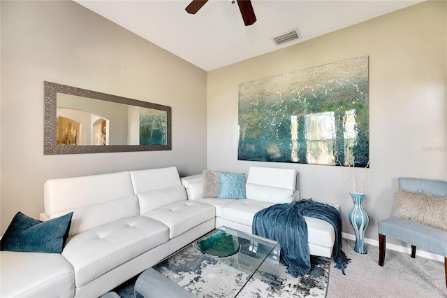 carpeted living room with ceiling fan