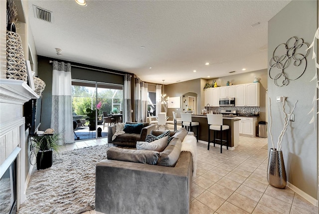 tiled living room with a textured ceiling