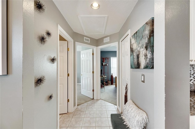 hall with light tile patterned floors