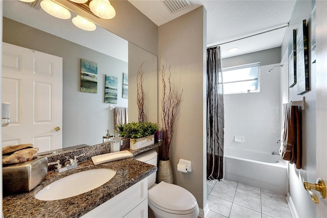 full bathroom featuring shower / bath combo, vanity, tile patterned floors, toilet, and a textured ceiling