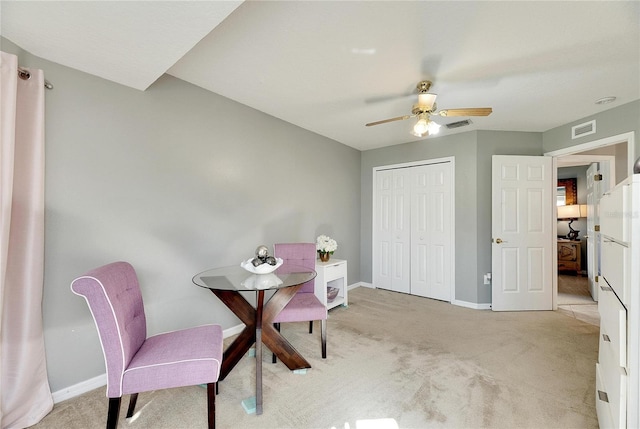 carpeted dining room featuring ceiling fan