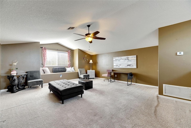 carpeted living room with a textured ceiling, vaulted ceiling, and ceiling fan