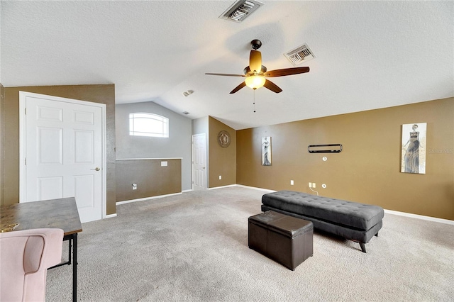 living area with light colored carpet, ceiling fan, and lofted ceiling