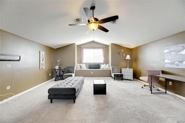 sitting room with carpet, ceiling fan, lofted ceiling, and a textured ceiling