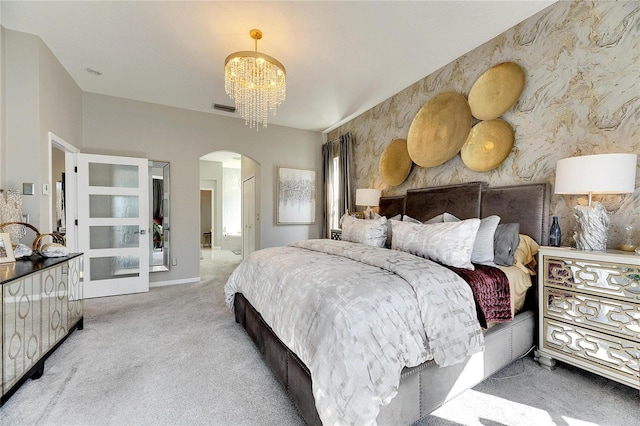 carpeted bedroom with a notable chandelier