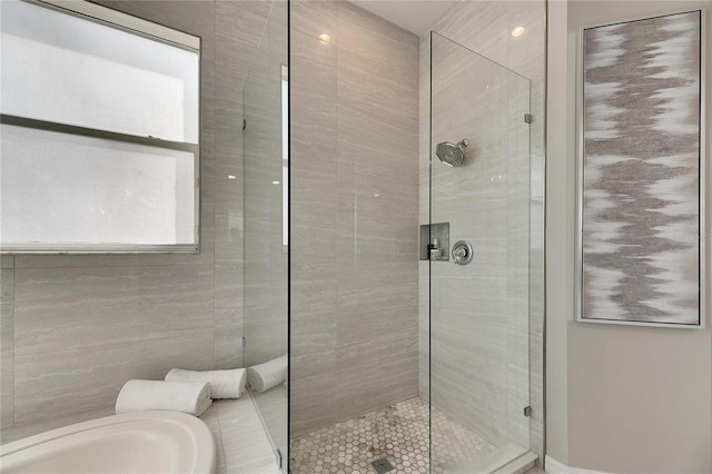 bathroom with a shower with door