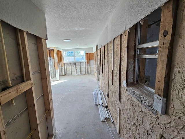 corridor featuring a textured ceiling